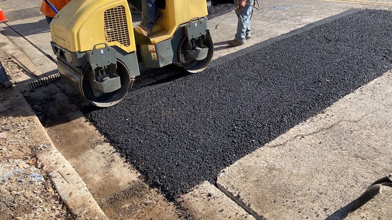 Asphalt repair job in Nashville TN. This is a an asphalt trench repair job for a Metro street patch. The Nashville asphalt contractor is using skid steer to pinch the edges of the asphalt, to get ready for a seamless infrared repair.