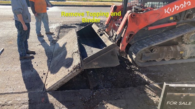Asphalt contracts in Nashville TN image of an asphalt trench repair. They are removing asphalt topping and binder