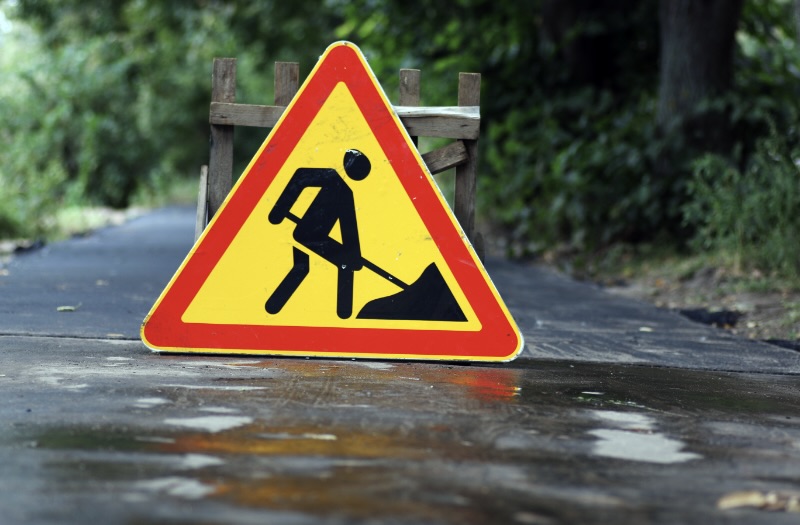 Asphalt Repair sign in the driveway of a Nashville home owner getting an asphalt overlay and sealcoating on his property