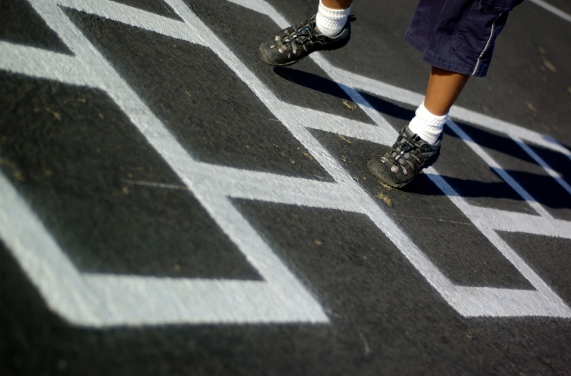 Image of a child playing on recreational preformed thermoplastic line markings in Davidson County, TN