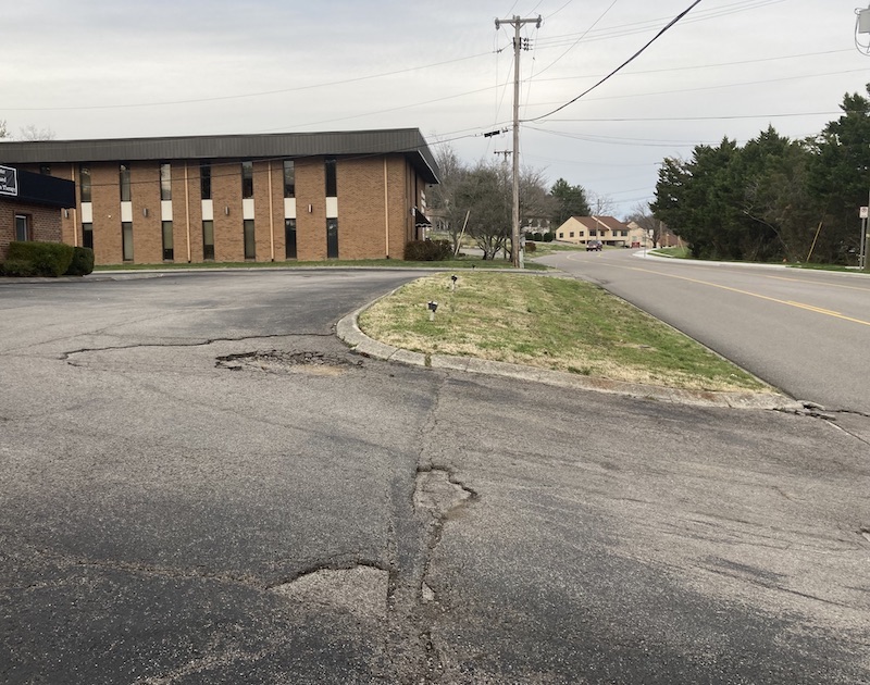 Bellevue TN Business with damaged parking lot. Asphalt parking lot pothole repair is needed.