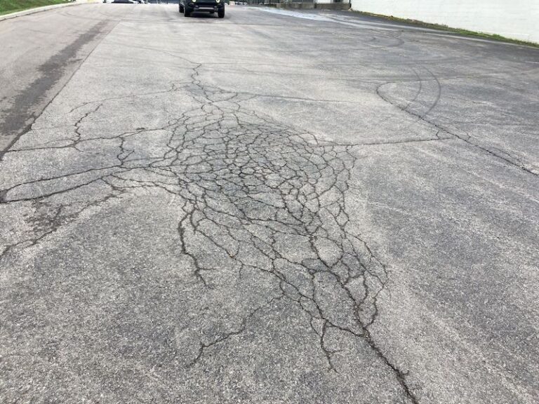Image of a Nashville Business in need of asphalt patching, crack repair, pothole repair, and sealcoating for their parking lot