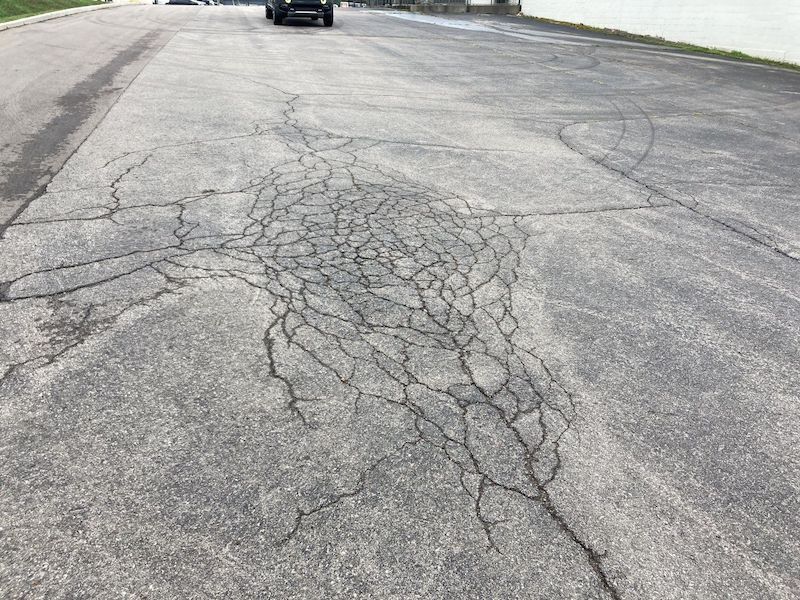 Image of a Nashville Business in need of asphalt patching, crack repair, pothole repair, and sealcoating for their parking lot