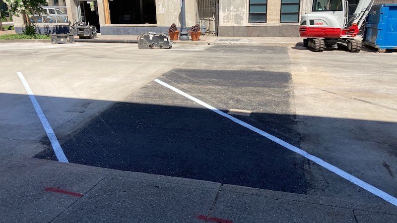 Infrared asphalt patching job in Murfreesboro, TN with two line striping lines added for a business in Murfreesboro TN, Rutherford County