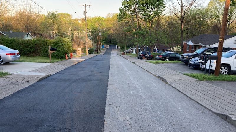 Asphalt milling and paving services on a street in Nashville, Tennessee.